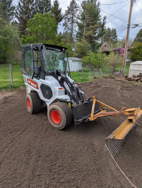 Bobcat grading and leveling yard