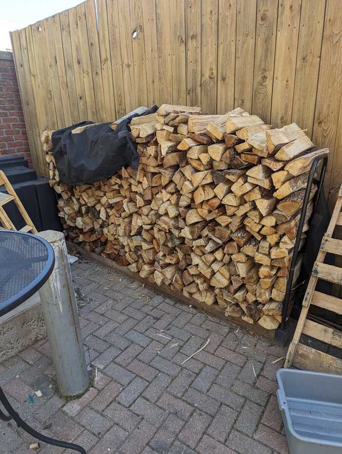 Firewood neatly stacked on customer patio