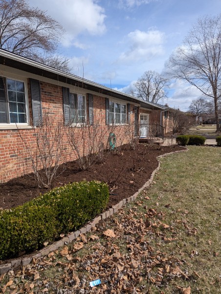 Mulched front garden bed along house